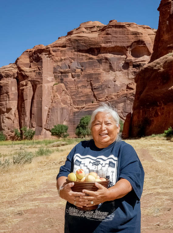 <p>Ancestral peach seeds, which are still sown in Canyon de Chelly National Monument, produce trees that are more drought resistant and live longer, according to Reagan Wytsalucy, a member of the Navajo Nation and an assistant professor with Utah State University Extension. The area’s peach orchards were largely destroyed by the U.S. Army in the mid-1800s, but people such as Wytsalucy and Sylvia Watchman (pictured) are working to propagate these traditional strains.</p>