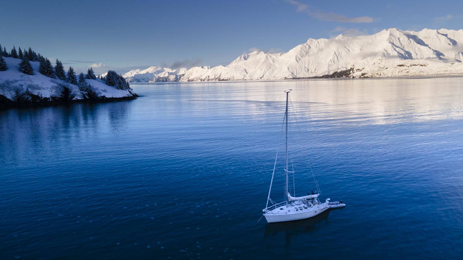 <p>The Madrona on a still and sunny day. Using Wolfrom’s drone to snap aerial pictures while at sea was “difficult at best,” he said. On the machine's inaugural outing, Wolfrom accidentally flew the drone into one of the mast’s guy lines as the boat was pulling out of Seward. In the captain’s attempt to save the spiraling drone, he cut his palm, prompting an emergency room visit and five stitches. </p>