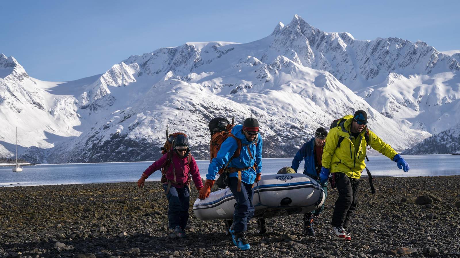 <p>The group hauls the dinghy through the tidal zone, stashing it high enough to prevent it from being swept back to sea while they ski. Navigating between the sailboat, the dinghy and the shore was a continual challenge. “Getting wet was not an option,” Wolfrom said, as hypothermia this far from the nearest town could be life-threatening.</p>