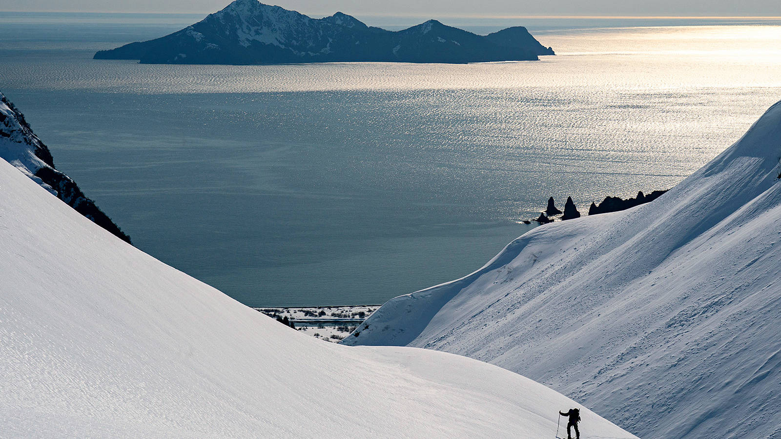<p>During their time in the park, the only human presence the group encountered was a single helicopter that flew overhead. Here, Goodell climbs an unnamed peak above Bulldog Cove.</p>