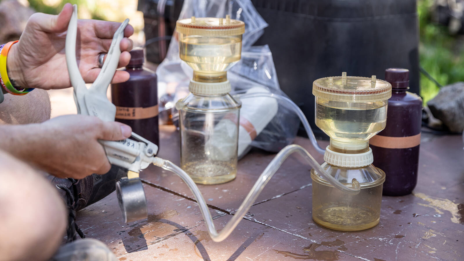 <p>Weinmann filters water to measure chlorophyll so that the team can estimate the lake’s algae levels.</p>
