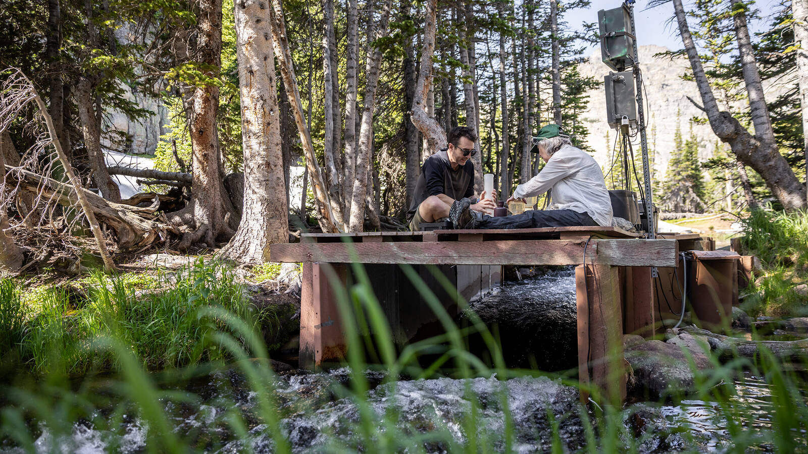 <p>Tim Weinmann, who was the field manager at the time, and Baron working on the platform built over The Loch’s outlet, where water exits the watershed.</p>